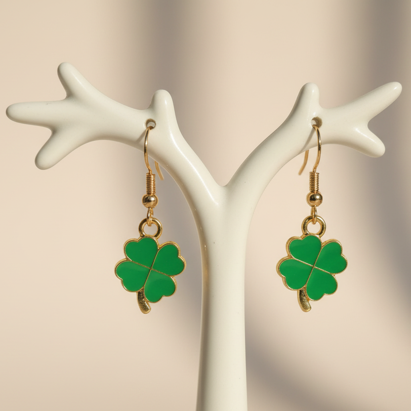 Four-leaf clover earrings on light background