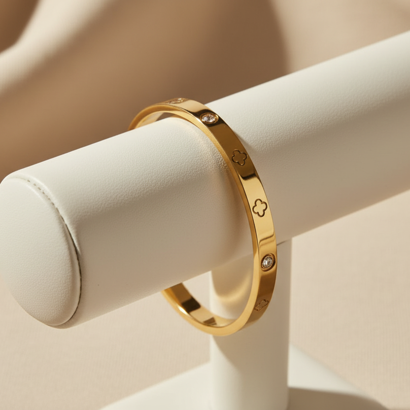 Gold clover bangle on a bracelet holder