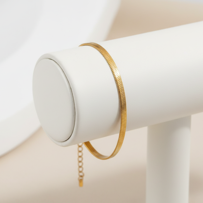 Gold herringbone bracelet on a bracelet holder