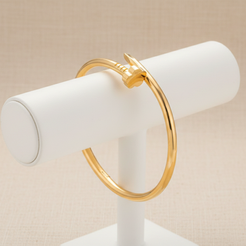 Gold nail bangle on holder with beige background